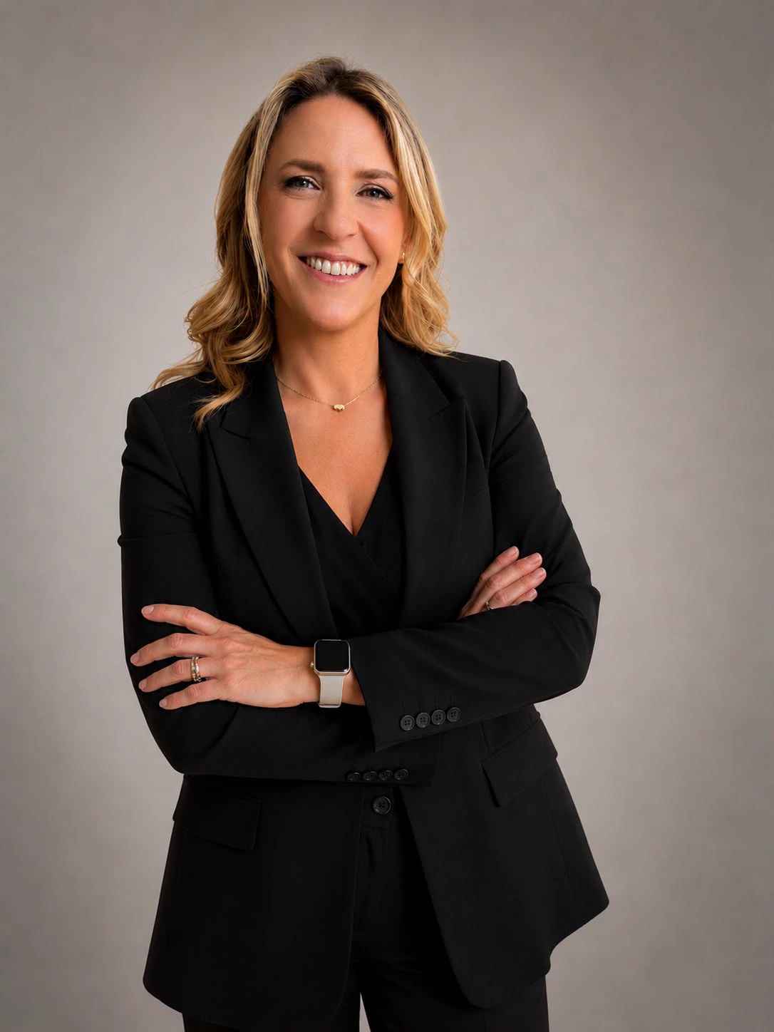 Carina Morris, Houston Realtor, in a dark suit with her arms crossed